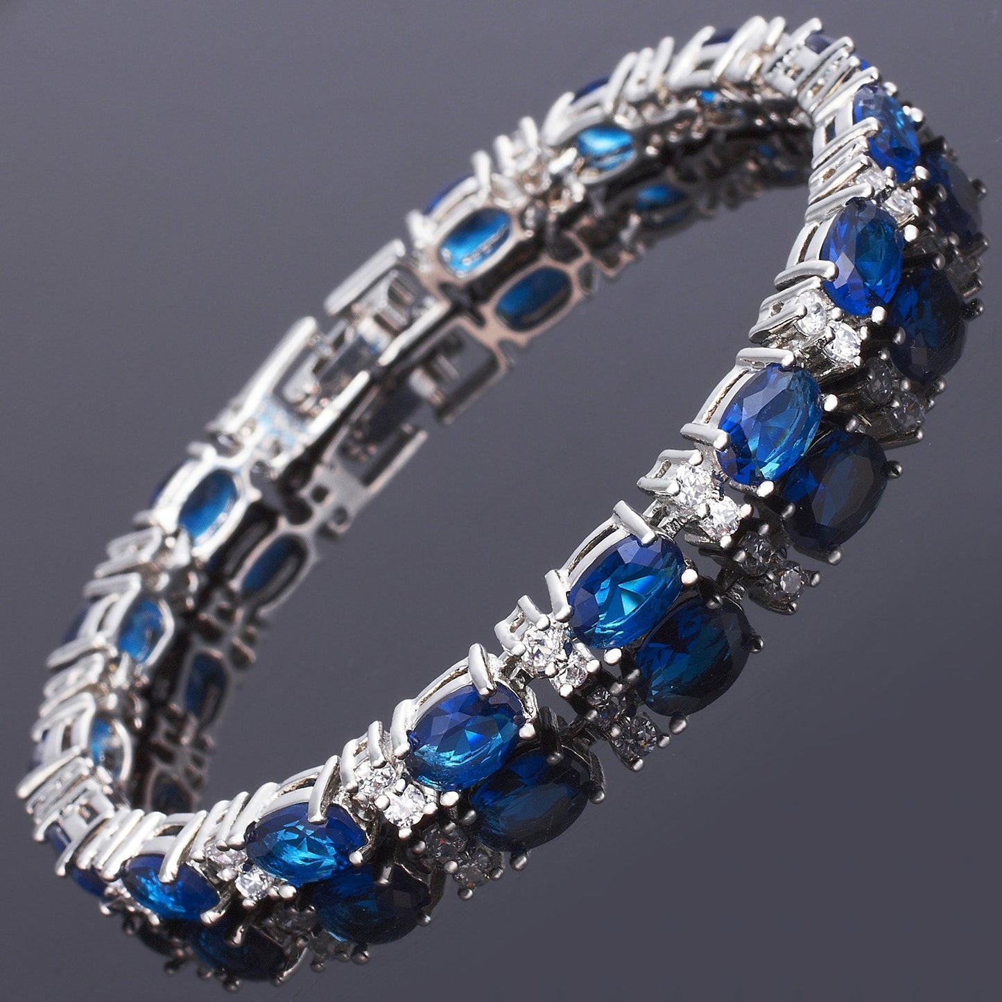 RIZILIA Oval Cut Multi-Color CZ Birthstone 18K White Gold Plated Tennis Bracelet, 7"